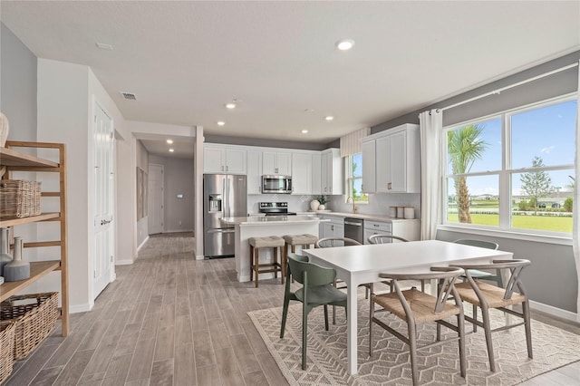 dining space with light hardwood / wood-style flooring