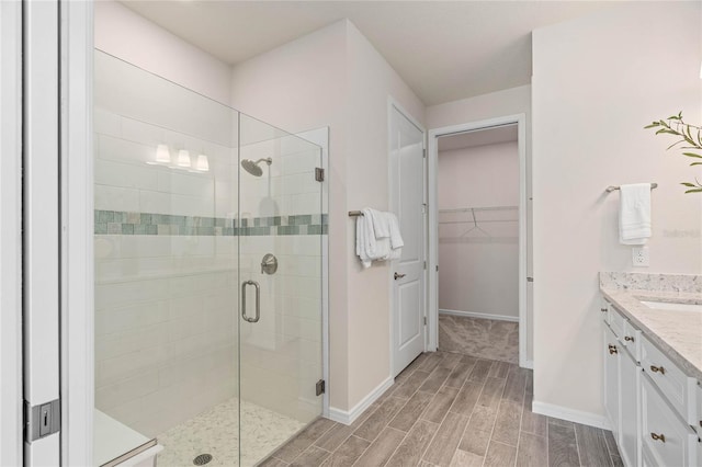 bathroom featuring vanity and a shower with shower door