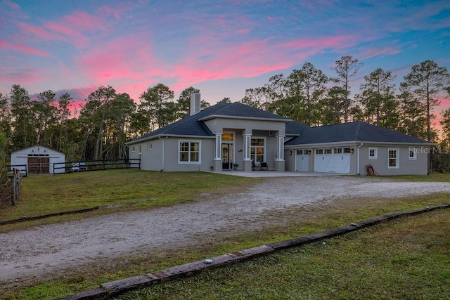 view of front of house with a yard and a garage