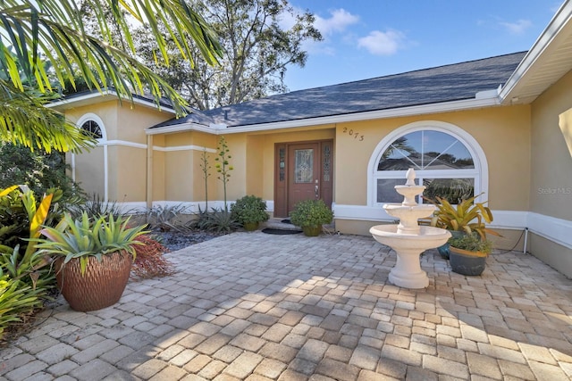 entrance to property with a patio