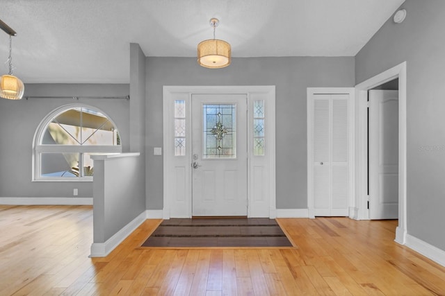 foyer featuring wood-type flooring and a textured ceiling