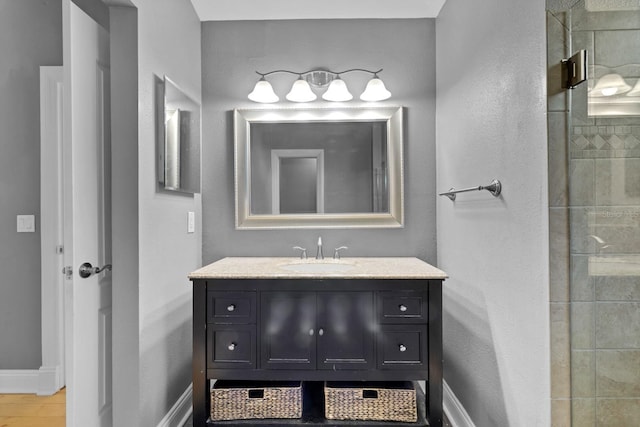 bathroom with vanity and a shower with shower door