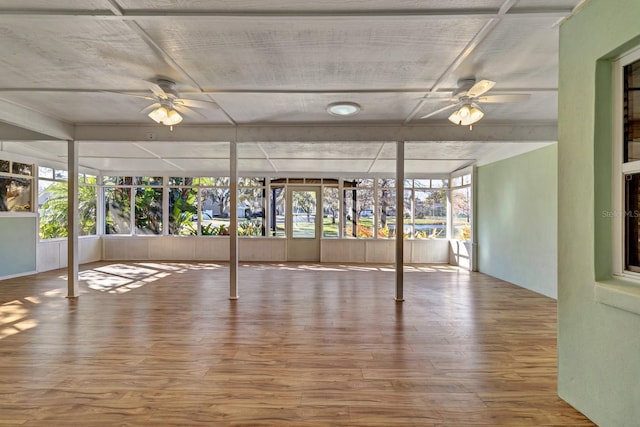 unfurnished sunroom featuring ceiling fan