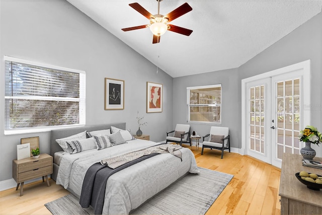 bedroom with wood-type flooring, lofted ceiling, access to outside, ceiling fan, and french doors