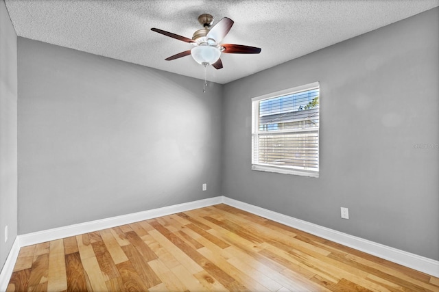 spare room featuring hardwood / wood-style floors, a textured ceiling, and ceiling fan