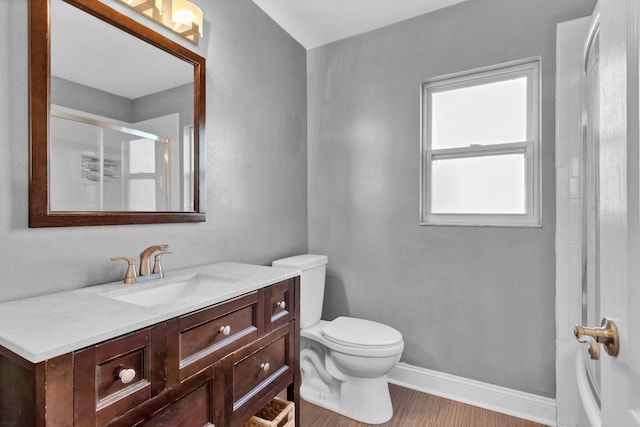 bathroom featuring walk in shower, vanity, toilet, and wood-type flooring