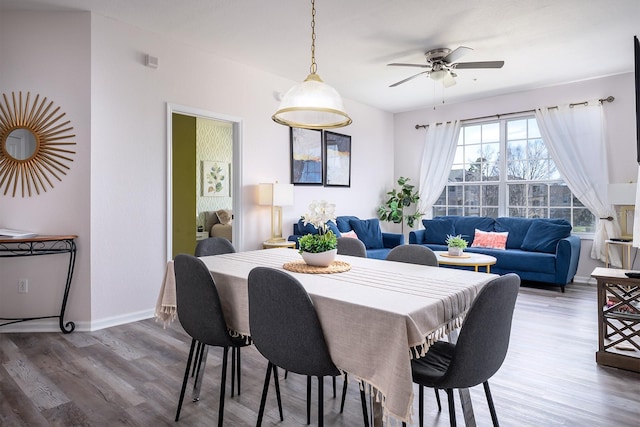 dining space with ceiling fan and wood-type flooring