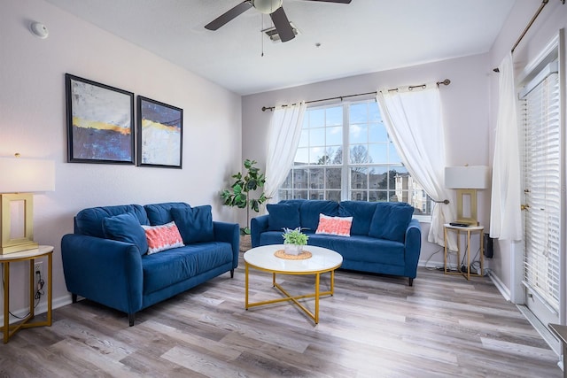 living room featuring ceiling fan and light hardwood / wood-style floors