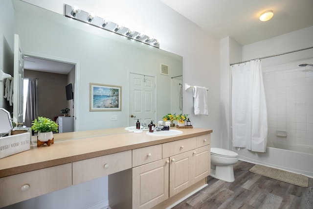 full bathroom featuring vanity, wood-type flooring, shower / bath combo, and toilet