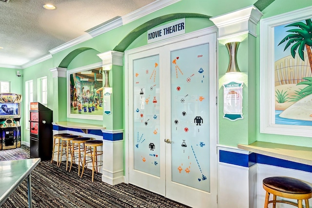 playroom with crown molding and a textured ceiling