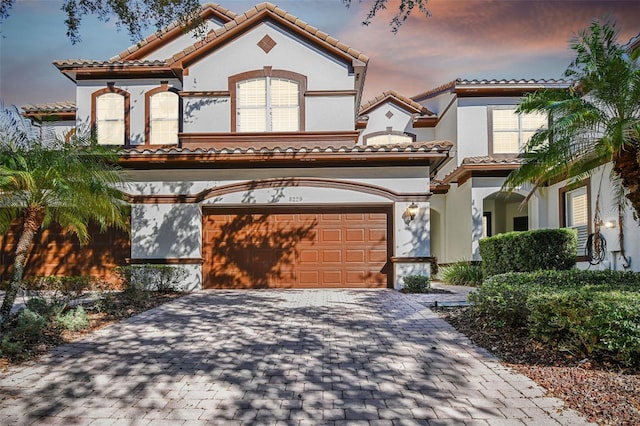 mediterranean / spanish-style home with a garage