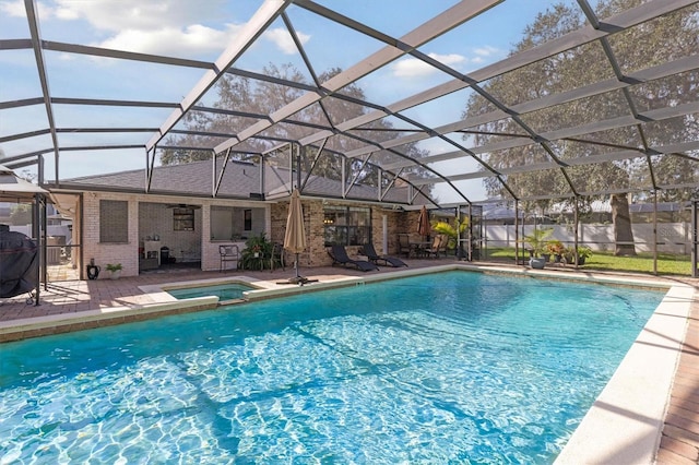 view of swimming pool featuring an in ground hot tub, glass enclosure, and a patio area