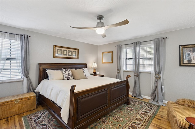 bedroom with ceiling fan and light wood-type flooring