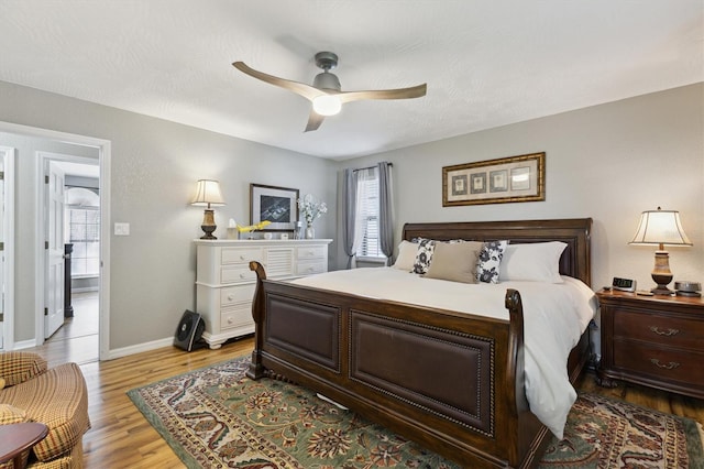 bedroom with light wood-type flooring and ceiling fan