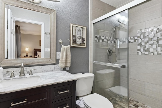 bathroom featuring vanity, toilet, and an enclosed shower