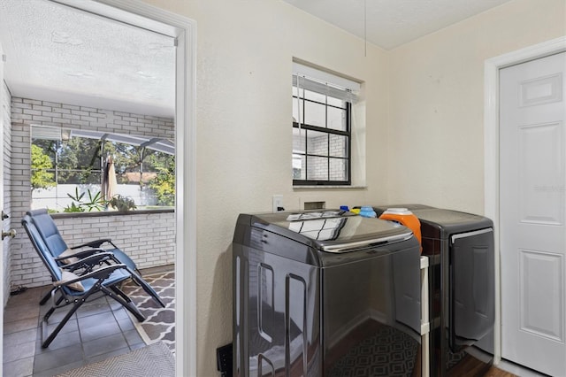 washroom featuring washer and dryer and a textured ceiling