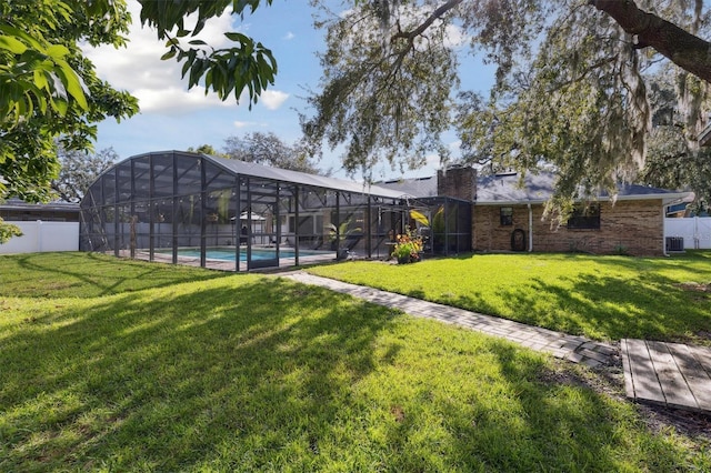 view of yard featuring glass enclosure