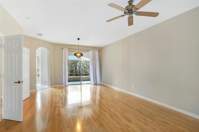 empty room featuring light hardwood / wood-style flooring and ceiling fan