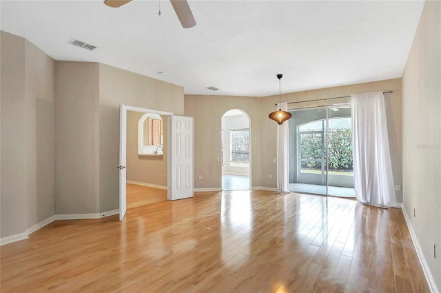 unfurnished room featuring ceiling fan and light wood-type flooring