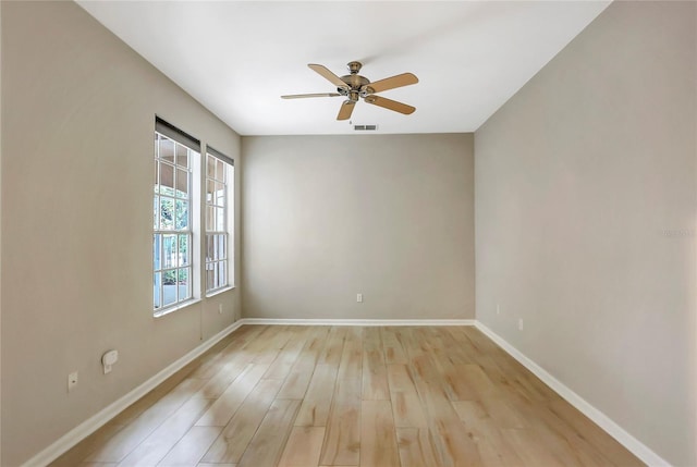 spare room featuring ceiling fan and light wood-type flooring