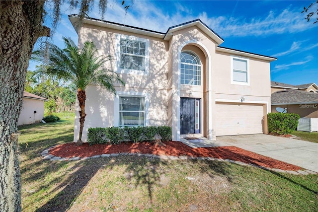 view of front of house with a garage and a front yard