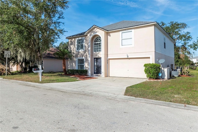 view of front of property featuring a front lawn and a garage