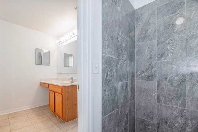 bathroom with tile patterned floors, vanity, and a shower