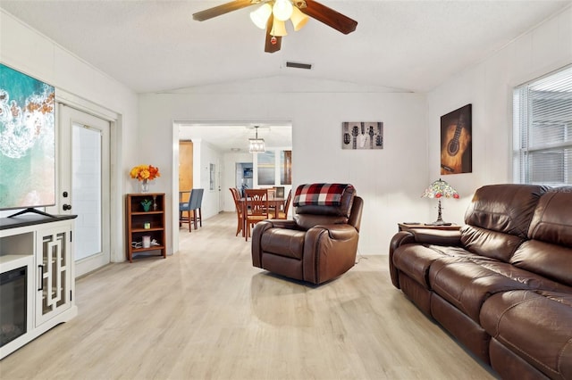 living room featuring a textured ceiling, ceiling fan, light hardwood / wood-style flooring, and vaulted ceiling