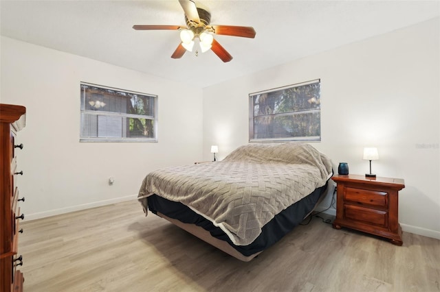 bedroom with light wood-type flooring and ceiling fan