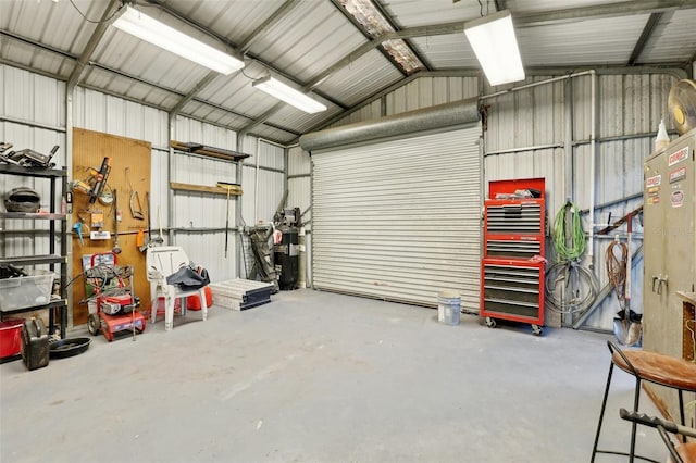 garage with a workshop area and electric water heater