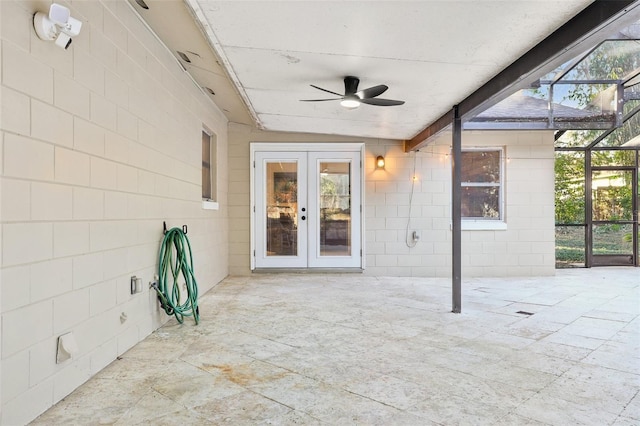 unfurnished sunroom featuring ceiling fan, lofted ceiling with beams, and french doors