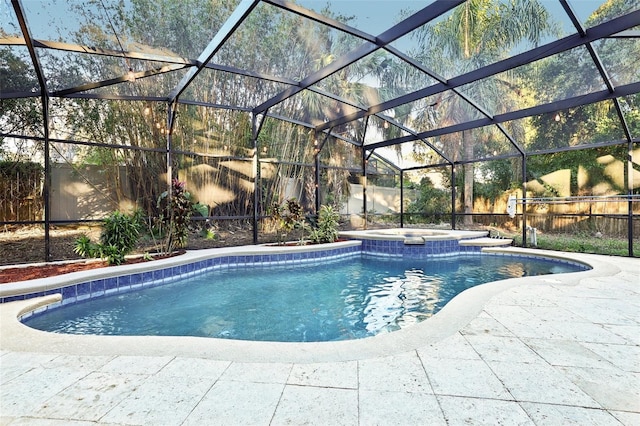 view of swimming pool with an in ground hot tub, a patio, and a lanai