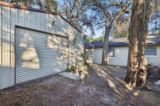 view of side of home featuring an outbuilding