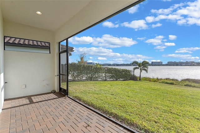 unfurnished sunroom with a water view