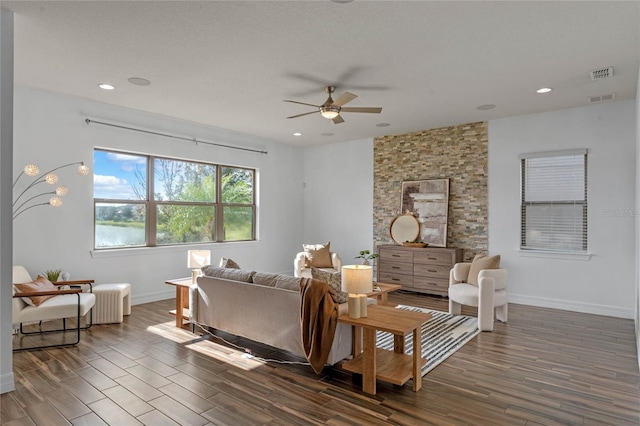 living room featuring ceiling fan and dark hardwood / wood-style floors