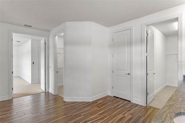 hallway with a textured ceiling