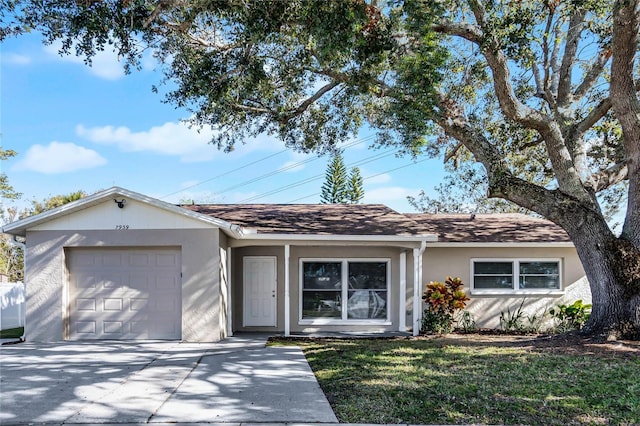 ranch-style home featuring a front yard and a garage