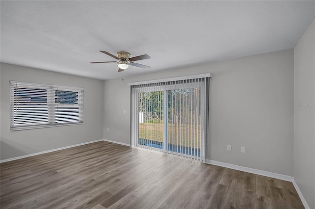 empty room with ceiling fan and light hardwood / wood-style floors