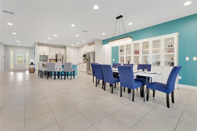 dining space featuring light tile patterned flooring