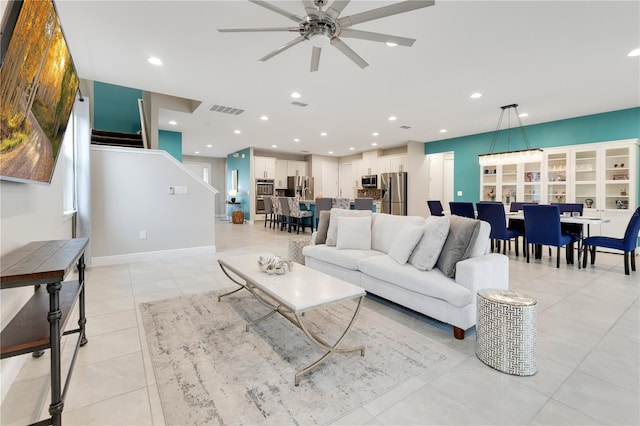 living room featuring ceiling fan and light tile patterned floors