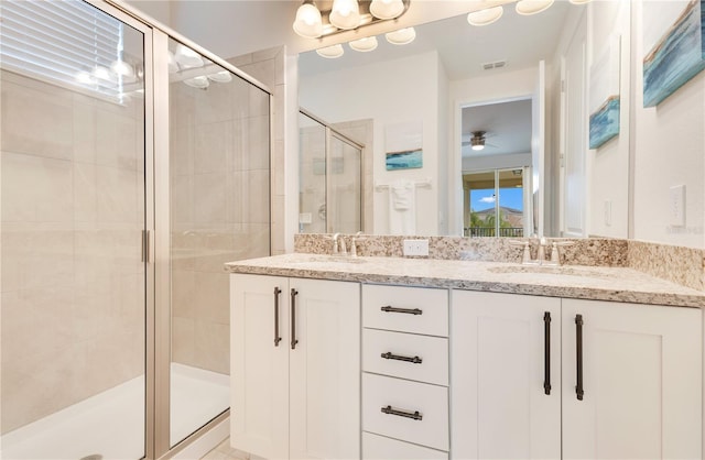 bathroom with ceiling fan, an enclosed shower, and vanity