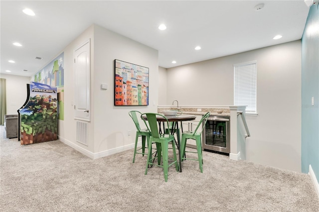 dining space featuring light carpet