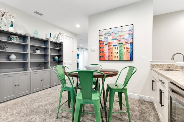 carpeted dining room featuring sink