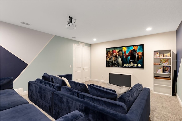 cinema room featuring light carpet