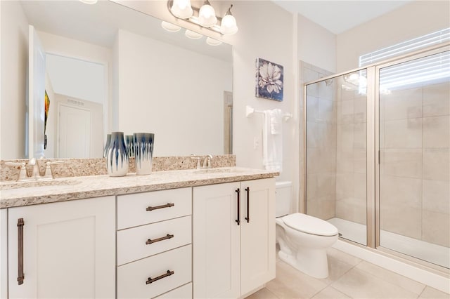 bathroom with toilet, tile patterned floors, an enclosed shower, and vanity