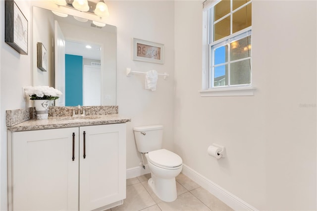 bathroom featuring toilet, vanity, and tile patterned flooring