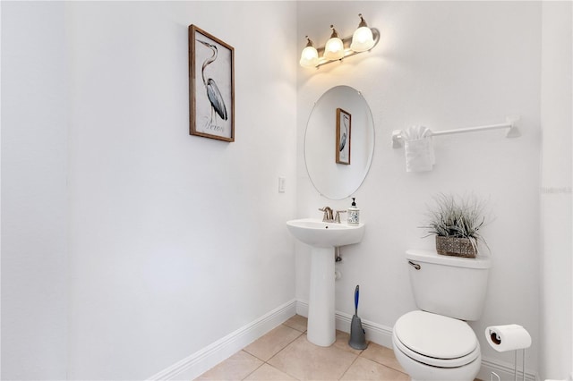 bathroom featuring toilet and tile patterned floors