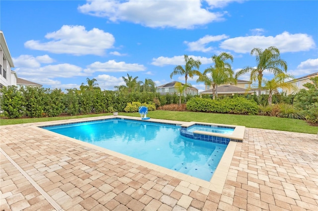 view of pool featuring an in ground hot tub, a yard, and a patio