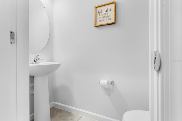 bathroom with tile patterned floors, toilet, and sink