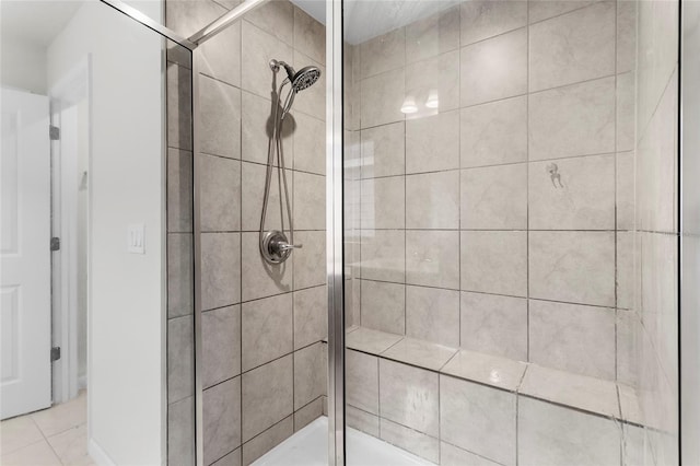 bathroom featuring tile patterned floors and a shower with shower door